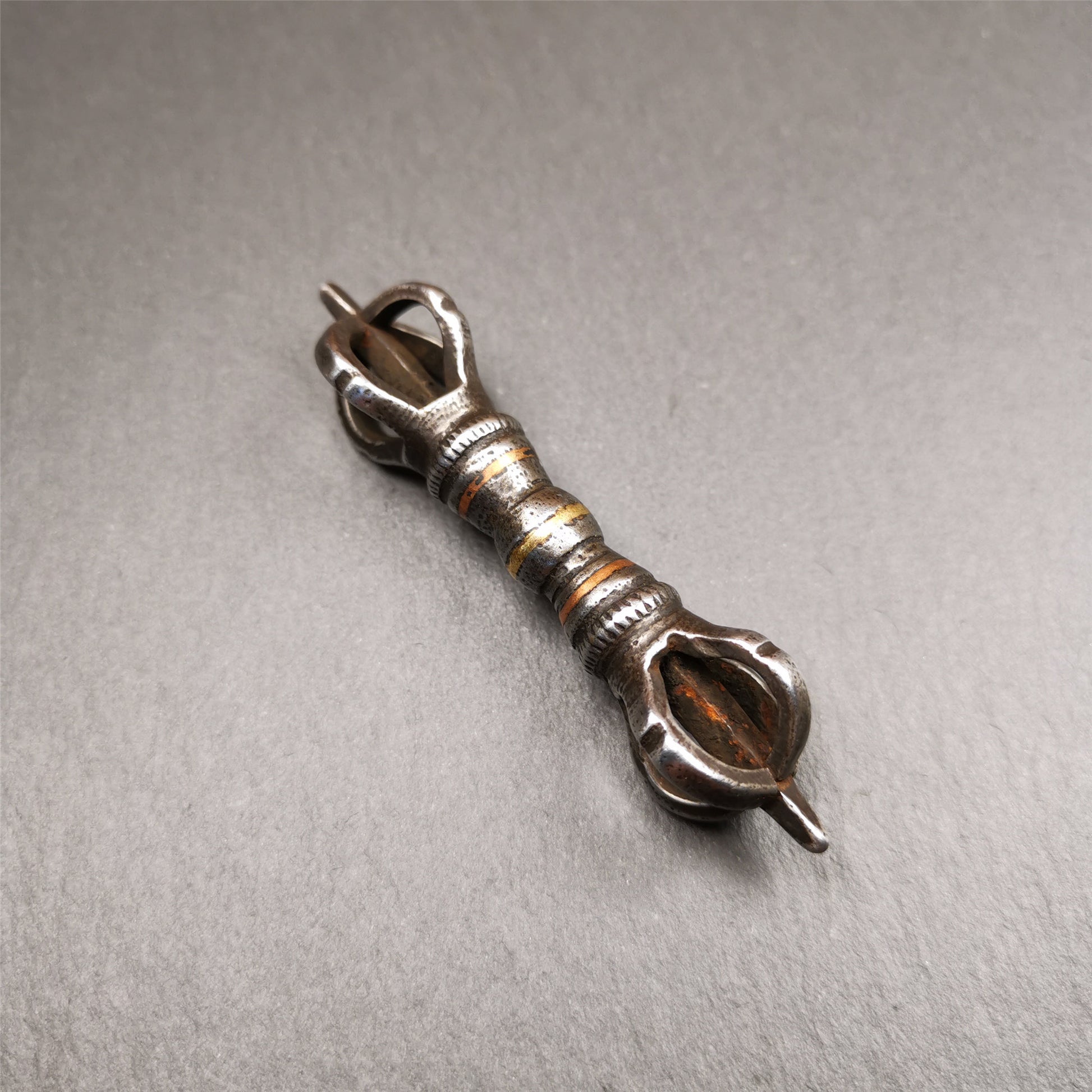 This unique vajra pendant was handmade by Tibetan craftsmen from Tibet in 1990s,from Hepo Town, Baiyu County, the birthplace of the famous Tibetan handicrafts. It is five - pronged Vajra,made of cold iron, black color,2.95 inches length.