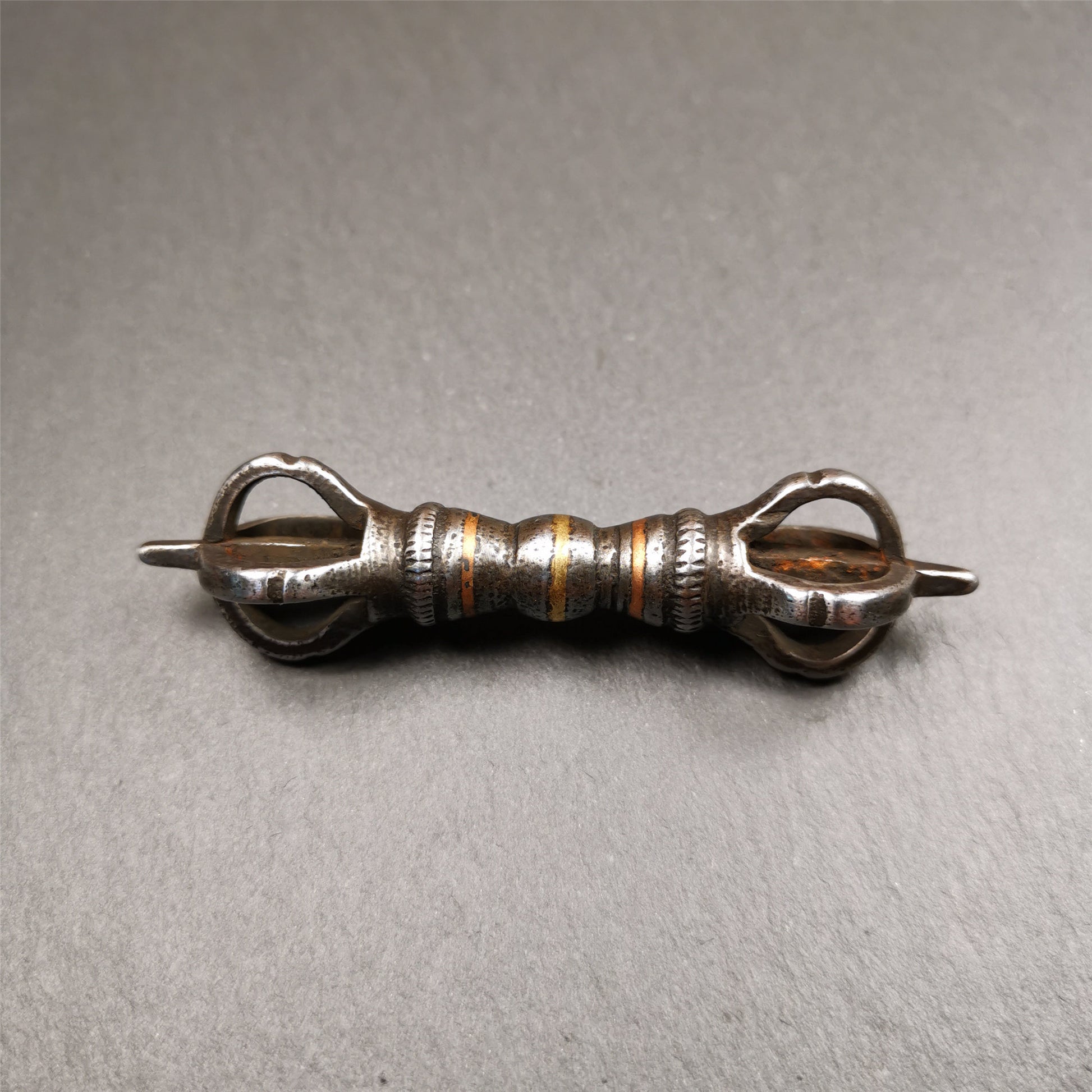 This unique vajra pendant was handmade by Tibetan craftsmen from Tibet in 1990s,from Hepo Town, Baiyu County, the birthplace of the famous Tibetan handicrafts. It is five - pronged Vajra,made of cold iron, black color,2.95 inches length.