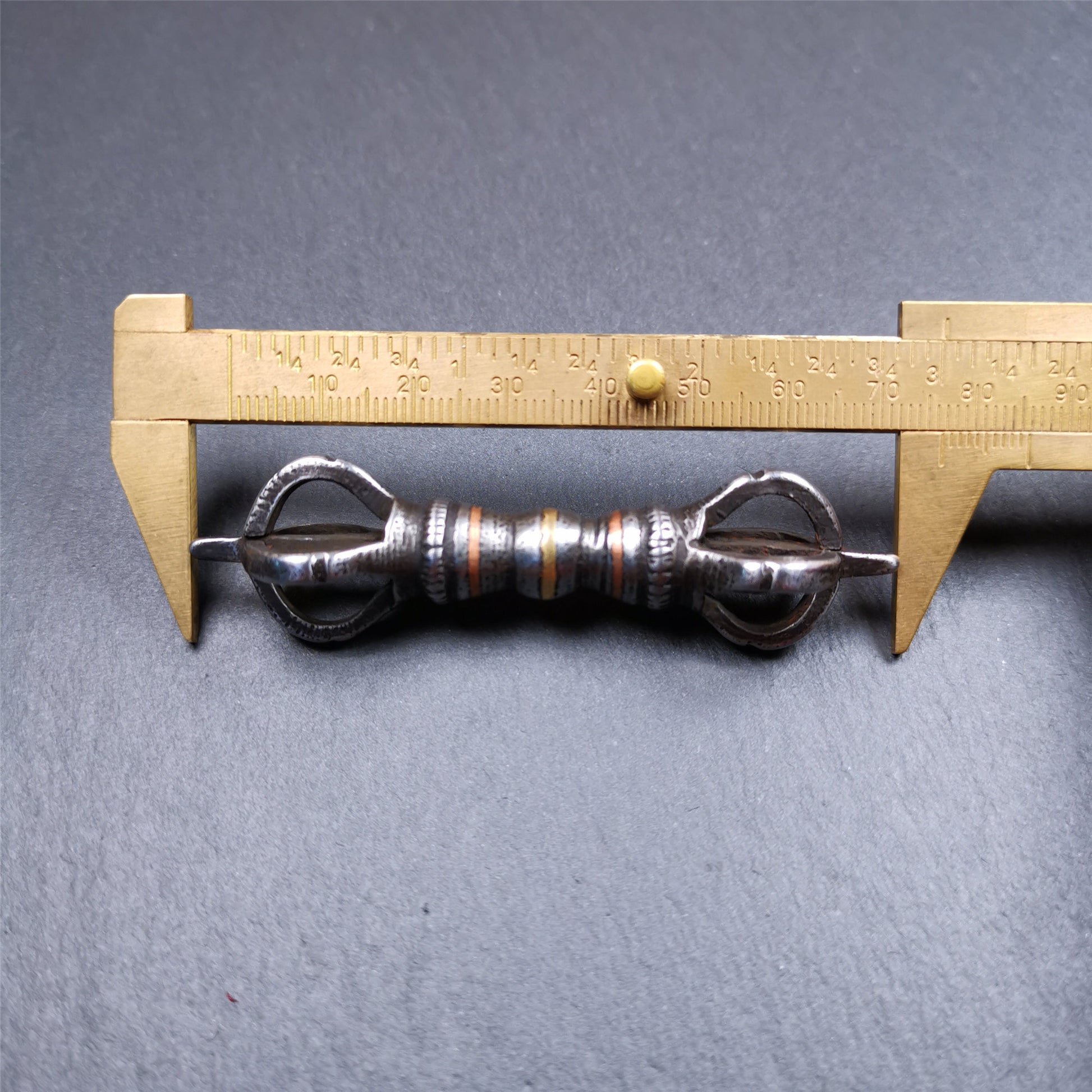 This unique vajra pendant was handmade by Tibetan craftsmen from Tibet in 1990s,from Hepo Town, Baiyu County, the birthplace of the famous Tibetan handicrafts. It is five - pronged Vajra,made of cold iron, black color,2.95 inches length.