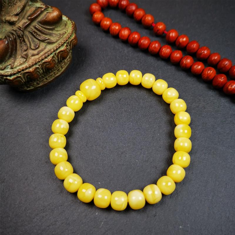 This amber beads bracelet was hand-woven by Tibetans from Baiyu County,Tibet. It is made of amber, yellow color,consists 1 main bead,25 small beads and 2 spacer beads,tie with elastic cord to fit your wrist.
