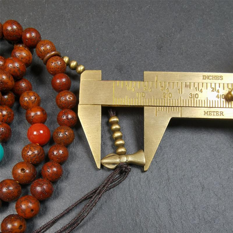 This old lotus seed mala was handmade from tibetan crafts man in Baiyu County,about 30 years old,blessed by lama. It's composed of 108 pcs 8mm lotus seed beads,then add some old agate,turquoise beads,1 pair of copper bead counters,and white copper guru bead on it.