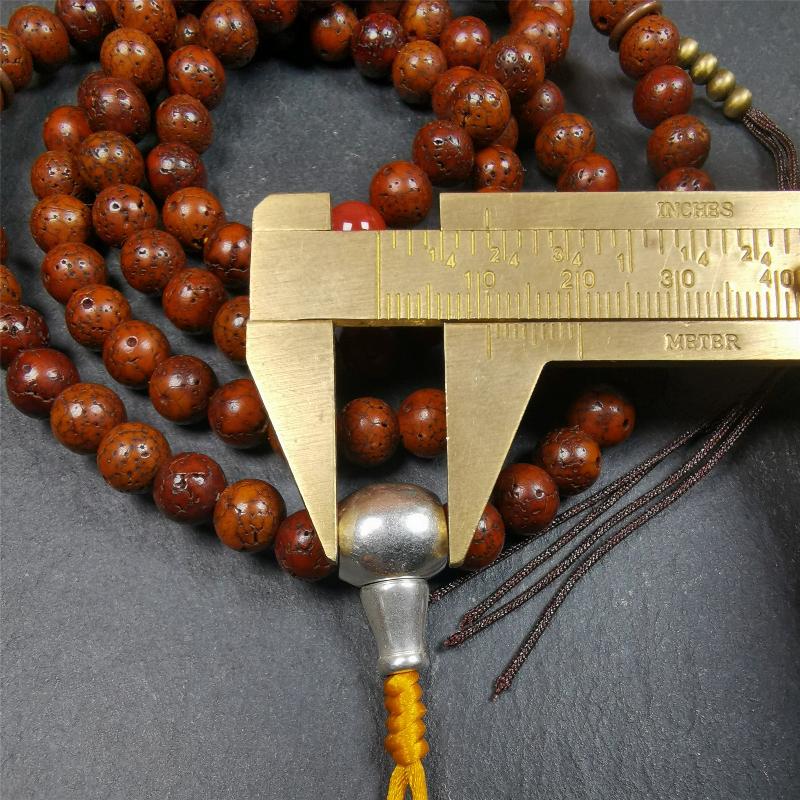 This old lotus seed mala was handmade from tibetan crafts man in Baiyu County,about 30 years old,blessed by lama. It's composed of 108 pcs 8mm lotus seed beads,then add some old agate,turquoise beads,1 pair of copper bead counters,and white copper guru bead on it.
