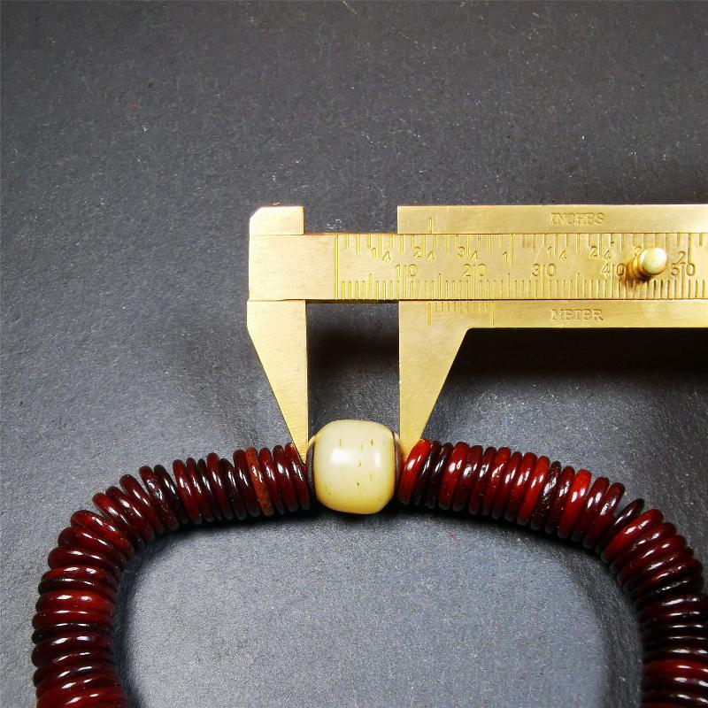 This bone carved mala beads is made by Tibetan craftsmen and come from Hepo Town, Baiyu County. It has 108 flat shape beads,1 spacer bead,and 1 guru bead,all hand carved with tibetan yak bone.