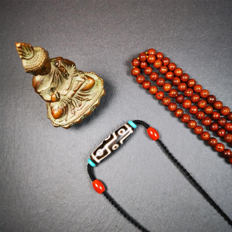 This 9 eyes dzi necklace was hand-woven by Tibetans from Baiyu County, the main bead is a 9 eyed  dzi bead, paired with 2 small agate beads and 2 turquoise spacer beads,about 30 years old.