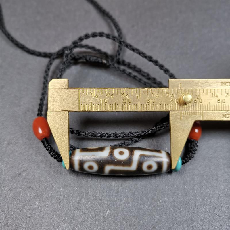 This 9 eyes dzi necklace was hand-woven by Tibetans from Baiyu County, the main bead is a 9 eyed dzi bead, paired with 2 small agate beads and 2 turquoise spacer beads,about 30 years old.
