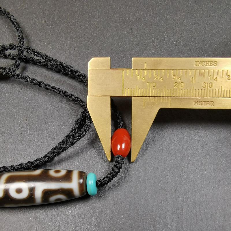 This 9 eyes dzi necklace was hand-woven by Tibetans from Baiyu County, the main bead is a 9 eyed dzi bead, paired with 2 small agate beads and 2 turquoise spacer beads,about 30 years old.