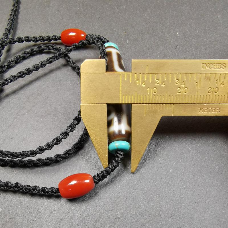 This 9 eyes dzi necklace was hand-woven by Tibetans from Baiyu County, the main bead is a 9 eyed dzi bead, paired with 2 small agate beads and 2 turquoise spacer beads,about 30 years old.