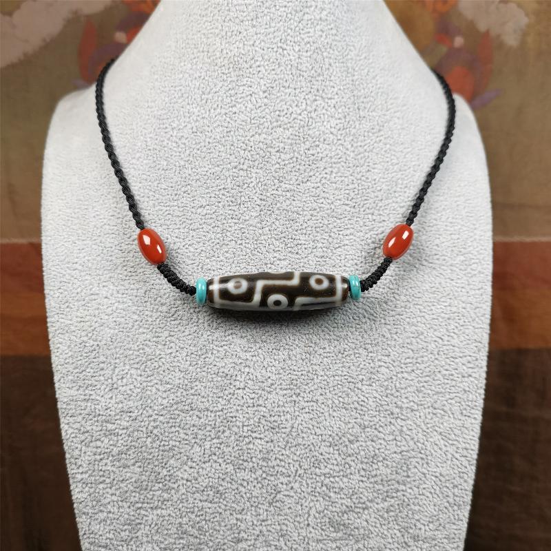 This 9 eyes dzi necklace was hand-woven by Tibetans from Baiyu County, the main bead is a 9 eyed dzi bead, paired with 2 small agate beads and 2 turquoise spacer beads,about 30 years old.