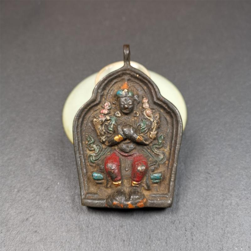 This maitreya statue was collected from Labrang Monastery,Qinghai,about 80 years old. It is an amulet of maitreya,made of copper,painted with mineral pigments,size is 2.95 by 1.97 inches,about 80 years old.