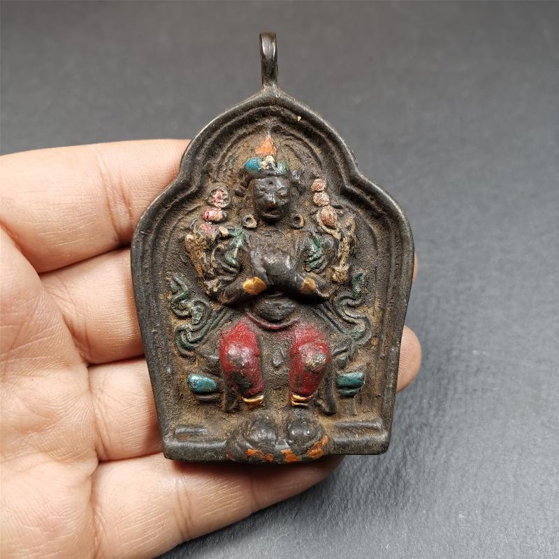 This maitreya statue was collected from Labrang Monastery,Qinghai,about 80 years old. It is an amulet of maitreya,made of copper,painted with mineral pigments,size is 2.95 by 1.97 inches,about 80 years old.