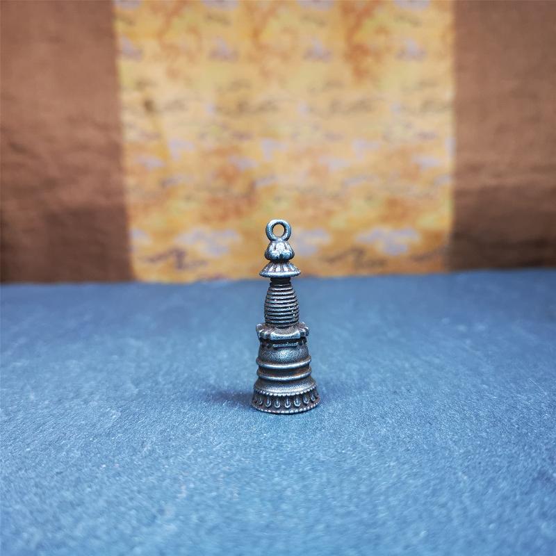 This beautiful stupa pendant is hand carved by Tibetan craftsmen from Tibet in 2000's. From Hepo Town, Baiyu County, the birthplace of the famous Tibetan handicrafts. It was made of cold iron,black color,1.38 inches height, a cross vajra seal at the bottom. You can make it into a pendant, or a keychain, or put it in your shrine.