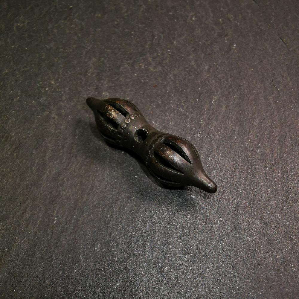 This vajra pendant was handmade by Tibetan craftsmen from Tibet,from Hepo Town, Baiyu County, the birthplace of the famous Tibetan handicrafts. It is nine-pronged vajra,made of brass,black color,1.5 inches length.