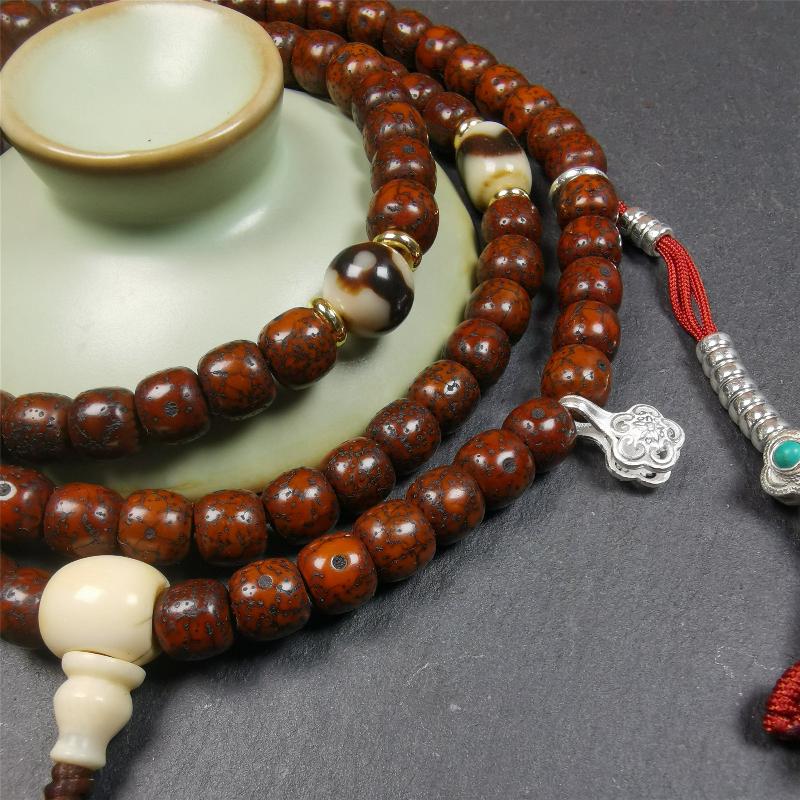 This old lotus seed mala was handmade from tibetan crafts man in Baiyu County,about 30 years old. It's composed of 108 lotus seed beads,then add some dzi beads,1 pair of silver bead counters,and ivory guru bead on i