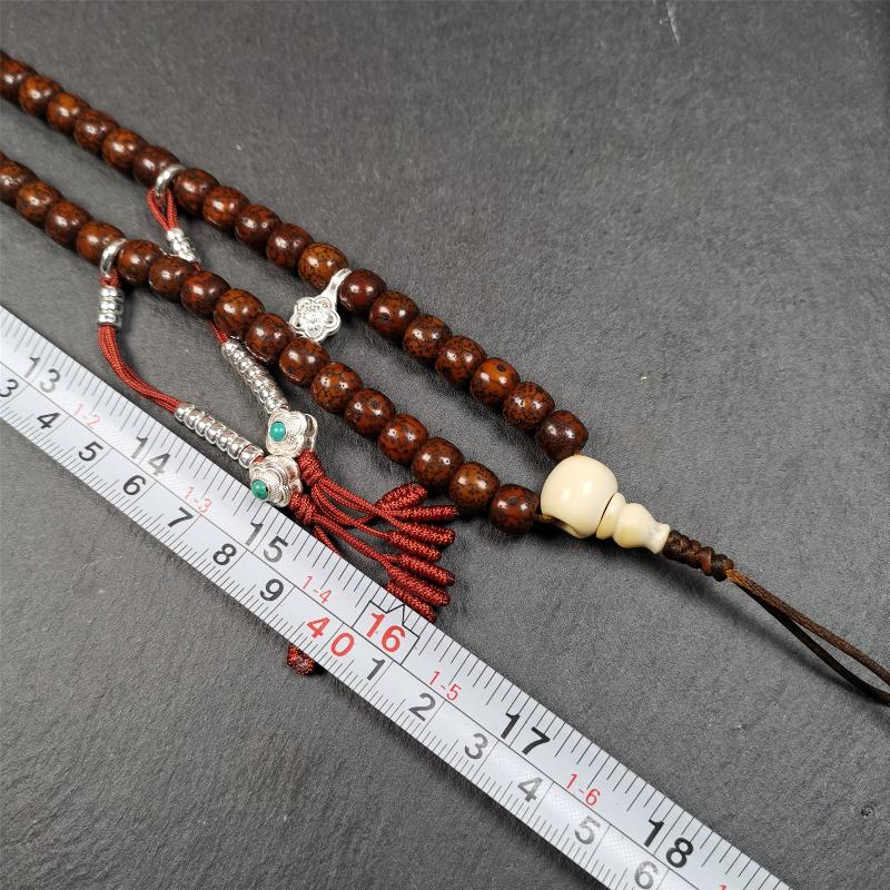 This old lotus seed mala was handmade from tibetan crafts man in Baiyu County,about 30 years old. It's composed of 108 lotus seed beads,then add some dzi beads,1 pair of silver bead counters,and ivory guru bead on i