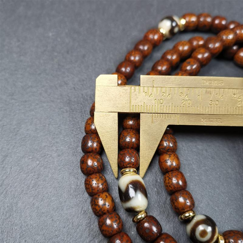 This old lotus seed mala was handmade from tibetan crafts man in Baiyu County,about 30 years old. It's composed of 108 lotus seed beads,then add some dzi beads,1 pair of silver bead counters,and ivory guru bead on i