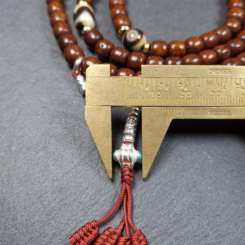 This old lotus seed mala was handmade from tibetan crafts man in Baiyu County,about 30 years old. It's composed of 108 lotus seed beads,then add some dzi beads,1 pair of silver bead counters,and ivory guru bead on i