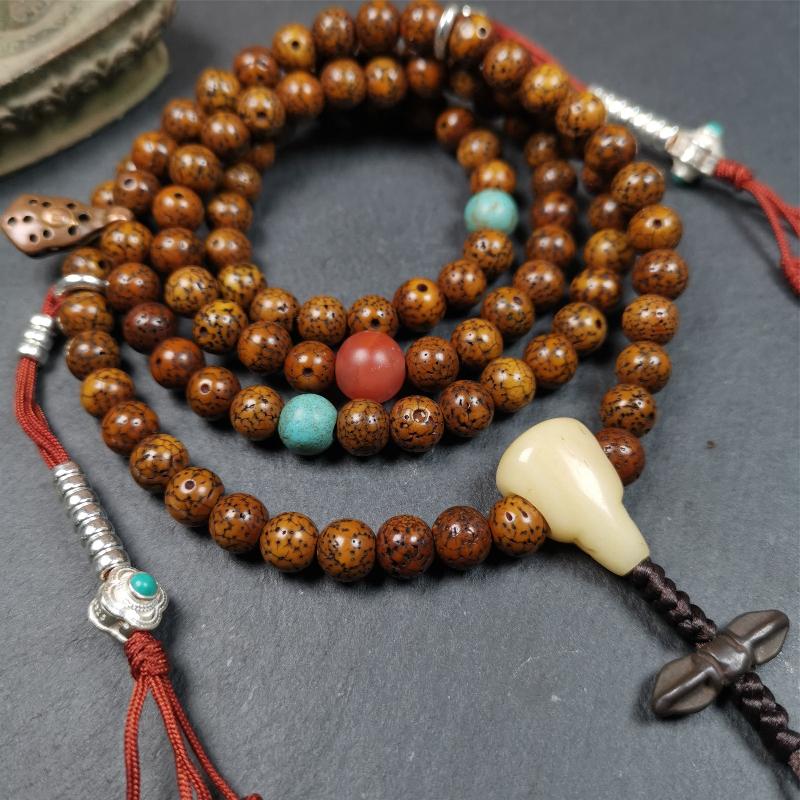 This old lotus seed mala was handmade from tibetan crafts man in Baiyu County,about 30 years old. It's composed of 108 pcs 7mm lotus seed beads,then add some old agate,turquoise beads,1 pair of silver bead counters,and bone guru bead on it.