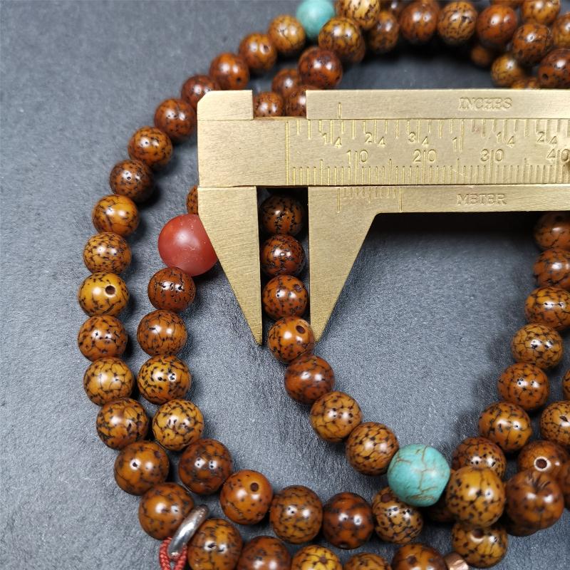 This old lotus seed mala was handmade from tibetan crafts man in Baiyu County,about 30 years old. It's composed of 108 pcs 7mm lotus seed beads,then add some old agate,turquoise beads,1 pair of silver bead counters,and bone guru bead on it.