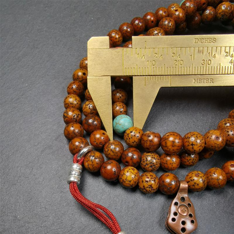 This old lotus seed mala was handmade from tibetan crafts man in Baiyu County,about 30 years old. It's composed of 108 pcs 7mm lotus seed beads,then add some old agate,turquoise beads,1 pair of silver bead counters,and bone guru bead on it.