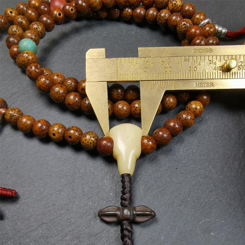This old lotus seed mala was handmade from tibetan crafts man in Baiyu County,about 30 years old. It's composed of 108 pcs 7mm lotus seed beads,then add some old agate,turquoise beads,1 pair of silver bead counters,and bone guru bead on it.
