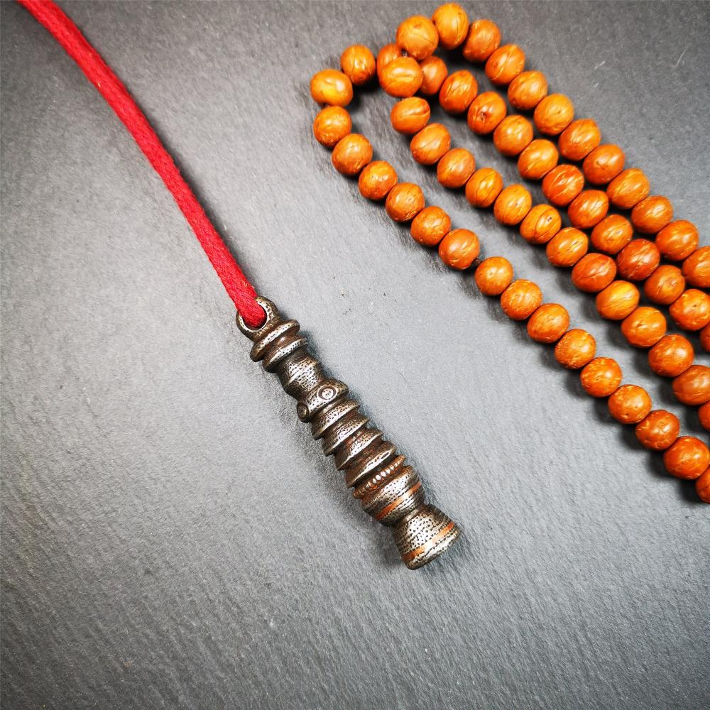 This beautiful stupa pendant is hand carved by Tibetan craftsmen from Tibet in 1990s. It was made of cold iron,inlaid copper dot,2.1 inches height,0.47 inch width. You can make it a pendant, or put it in your shrine.