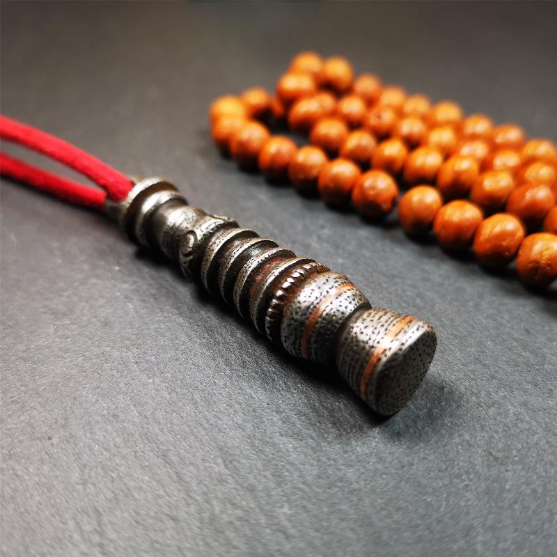 This beautiful stupa pendant is hand carved by Tibetan craftsmen from Tibet in 1990s. It was made of cold iron,inlaid copper dot,2.1 inches height,0.47 inch width. You can make it a pendant, or put it in your shrine.