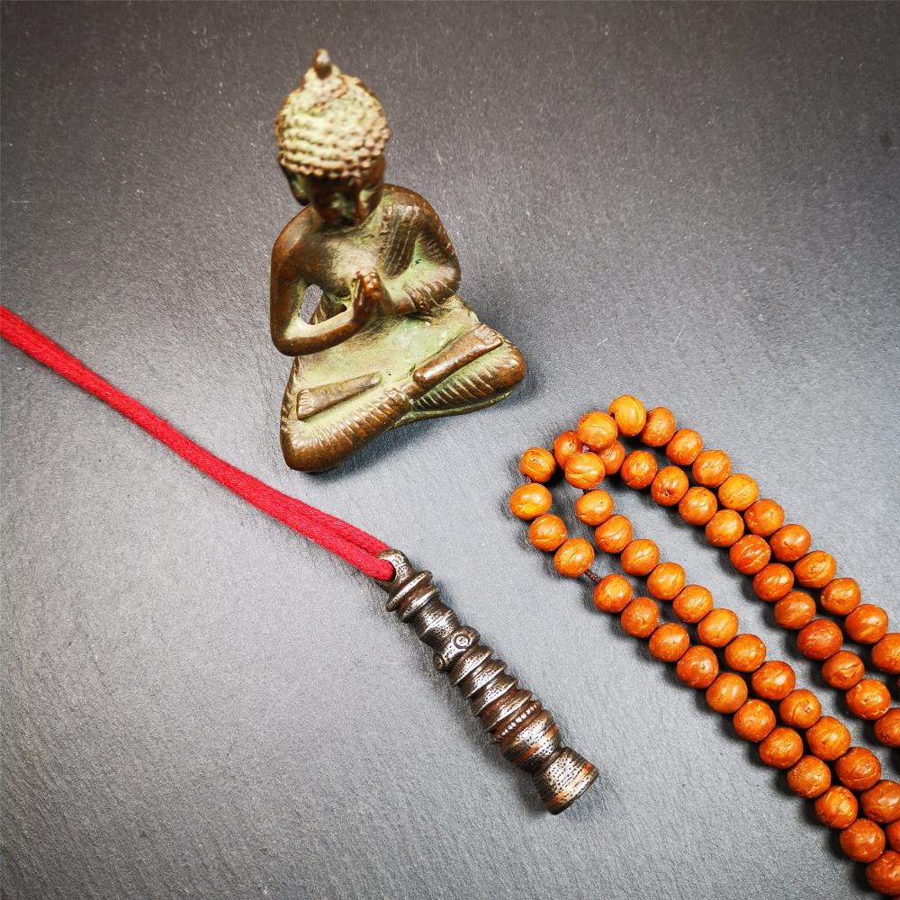 This beautiful stupa pendant is hand carved by Tibetan craftsmen from Tibet in 1990s. It was made of cold iron,inlaid copper dot,2.1 inches height,0.47 inch width. You can make it a pendant, or put it in your shrine.