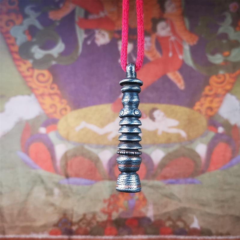 This beautiful stupa pendant is hand carved by Tibetan craftsmen from Tibet in 1990s. It was made of cold iron,inlaid copper dot,2.1 inches height,0.47 inch width. You can make it a pendant, or put it in your shrine.