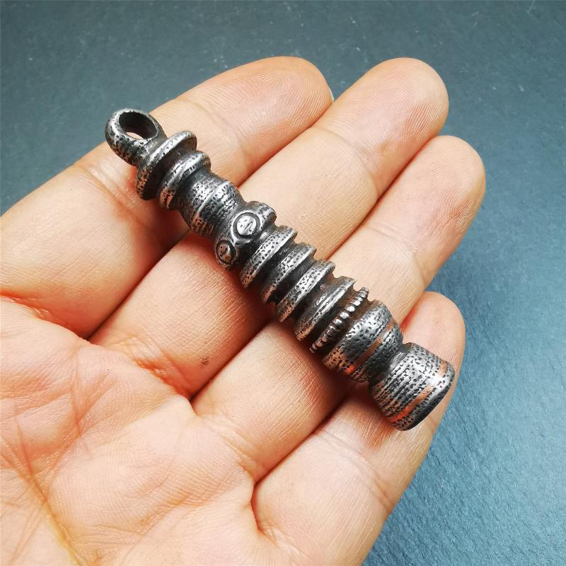 This beautiful stupa pendant is hand carved by Tibetan craftsmen from Tibet in 1990s. It was made of cold iron,inlaid copper dot,2.1 inches height,0.47 inch width. You can make it a pendant, or put it in your shrine.