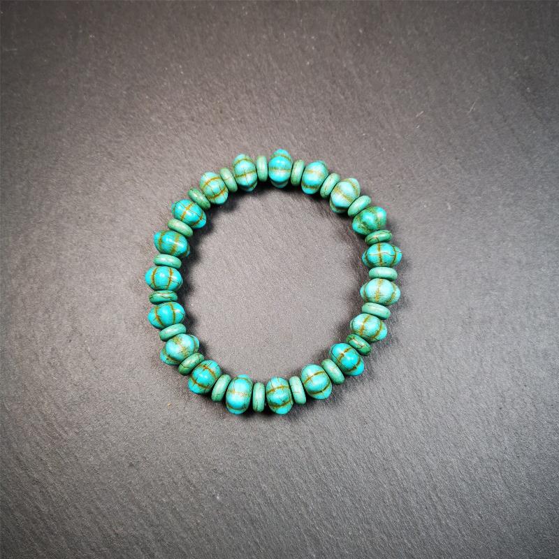 This beautiful turquoise bracelet is handmade from Tibet in 1980's. It's green color, made of turquoise, 19 hexagon beads and 19 spacer beads in total,7.4 inches circumference,0.47 width.