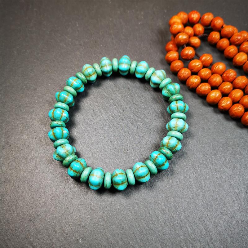This beautiful turquoise bracelet is handmade from Tibet in 1980's. It's green color, made of turquoise, 19 hexagon beads and 19 spacer beads in total,7.4 inches circumference,0.47 width.