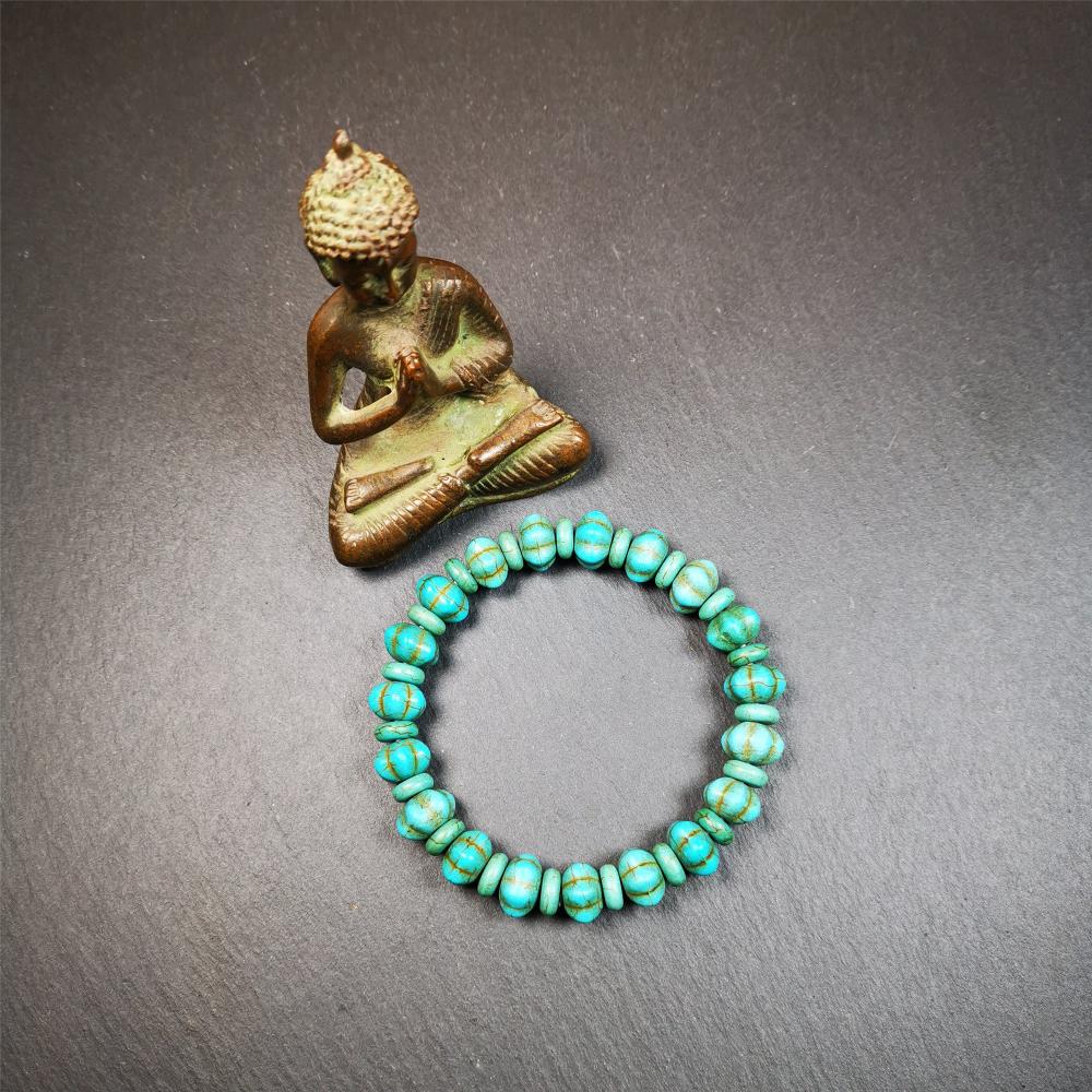 This beautiful turquoise bracelet is handmade from Tibet in 1980's. It's green color, made of turquoise, 19 hexagon beads and 19 spacer beads in total,7.4 inches circumference,0.47 width.