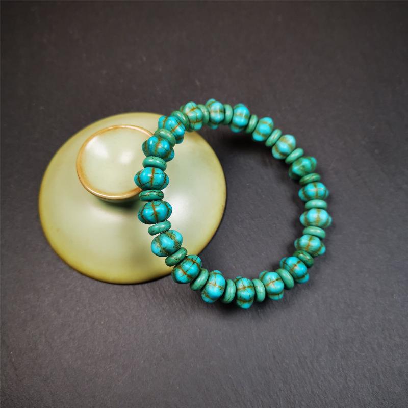 This beautiful turquoise bracelet is handmade from Tibet in 1980's. It's green color, made of turquoise, 19 hexagon beads and 19 spacer beads in total,7.4 inches circumference,0.47 width.