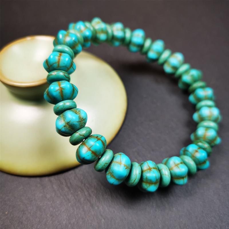This beautiful turquoise bracelet is handmade from Tibet in 1980's. It's green color, made of turquoise, 19 hexagon beads and 19 spacer beads in total,7.4 inches circumference,0.47 width.