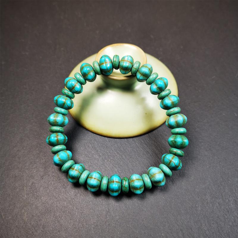 This beautiful turquoise bracelet is handmade from Tibet in 1980's. It's green color, made of turquoise, 19 hexagon beads and 19 spacer beads in total,7.4 inches circumference,0.47 width.