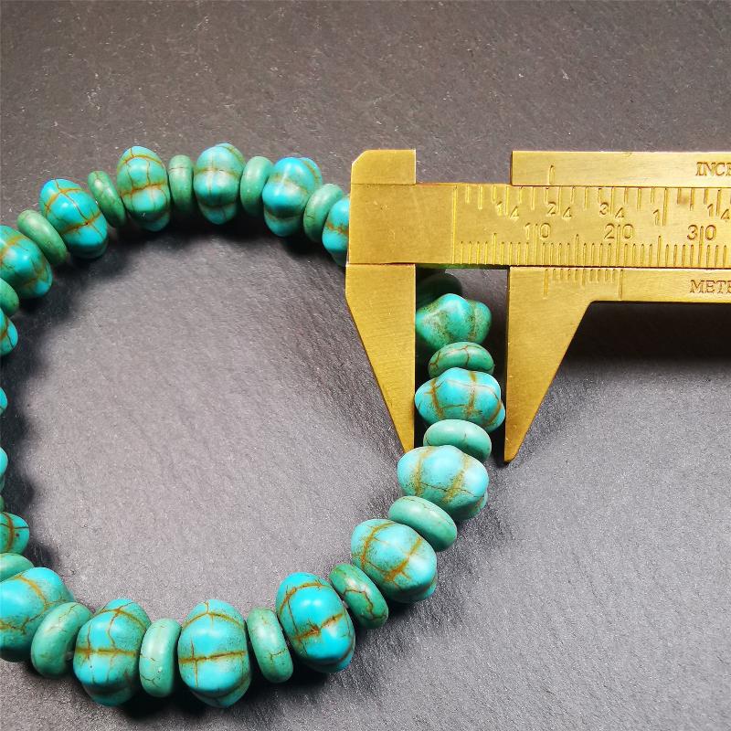 This beautiful turquoise bracelet is handmade from Tibet in 1980's. It's green color, made of turquoise, 19 hexagon beads and 19 spacer beads in total,7.4 inches circumference,0.47 width.