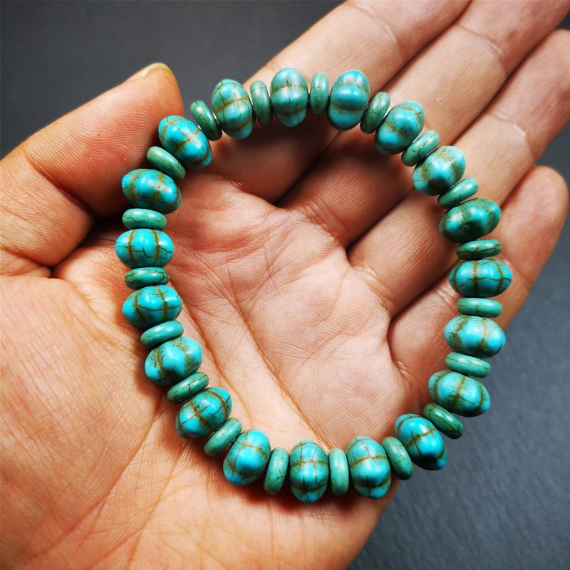 This beautiful turquoise bracelet is handmade from Tibet in 1980's. It's green color, made of turquoise, 19 hexagon beads and 19 spacer beads in total,7.4 inches circumference,0.47 width.