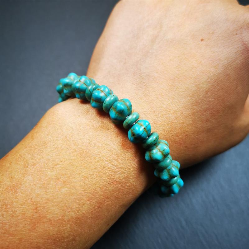 This beautiful turquoise bracelet is handmade from Tibet in 1980's. It's green color, made of turquoise, 19 hexagon beads and 19 spacer beads in total,7.4 inches circumference,0.47 width.