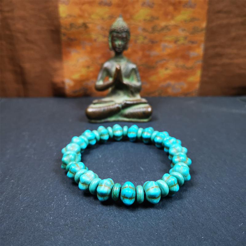 This beautiful turquoise bracelet is handmade from Tibet in 1980's. It's green color, made of turquoise, 19 hexagon beads and 19 spacer beads in total,7.4 inches circumference,0.47 width.