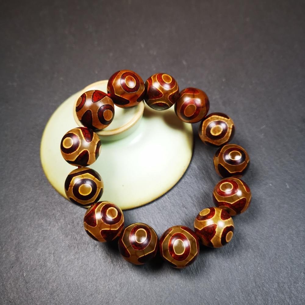 This 3 eyes bracelet was hand-woven by Tibetans,It's made of 3 eyes round dzi beads,brown color,diameter is 0.63", the circumference of bracelet is 7.5". It can be worn not only as a fashionable accessory but also holds cultural and religious significance.