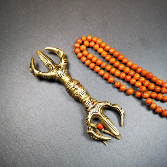 This unique vajra pendant was handmade by Tibetan craftsmen from Tibet in 2000's,from Hepo Town, Baiyu County, the birthplace of the famous Tibetan handicrafts. It is unique flat three - pronged Vajra,made of brass, yellow color,6.3 inches length. In tantric Buddhist practice, the vajra is a potent instrument with multifaceted meaning, symbolizing the adamantine state of existence of a Buddhist practitioner who has reached full enlightenment. The vajra is the archetypal symbol of tantric Buddhism.