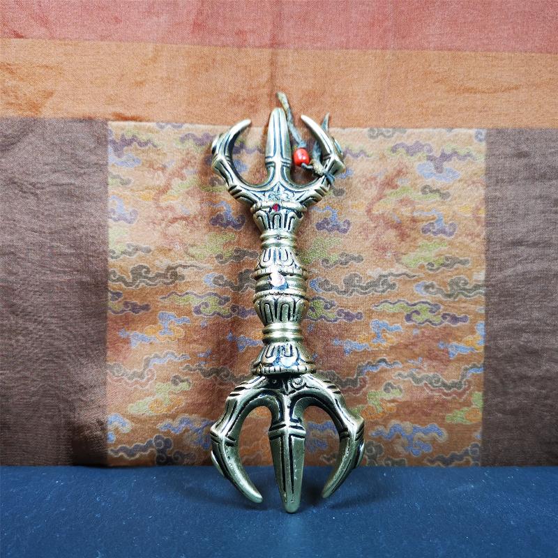 This unique vajra pendant was handmade by Tibetan craftsmen from Tibet in 2000's,from Hepo Town, Baiyu County, the birthplace of the famous Tibetan handicrafts. It is unique flat three - pronged Vajra,made of brass, yellow color,6.3 inches length. In tantric Buddhist practice, the vajra is a potent instrument with multifaceted meaning, symbolizing the adamantine state of existence of a Buddhist practitioner who has reached full enlightenment. The vajra is the archetypal symbol of tantric Buddhism.
