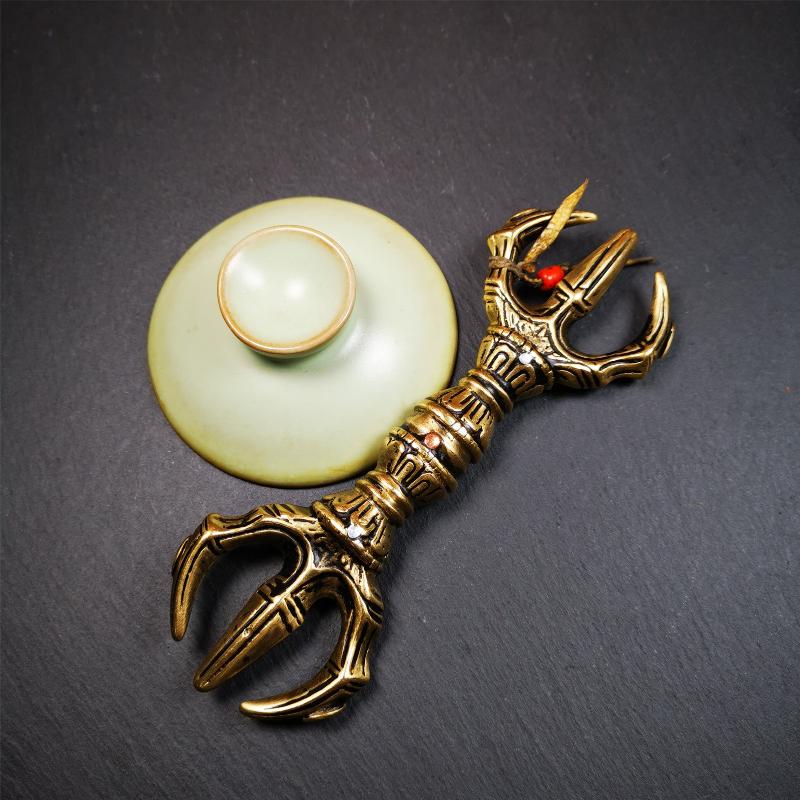 This unique vajra pendant was handmade by Tibetan craftsmen from Tibet in 2000's,from Hepo Town, Baiyu County, the birthplace of the famous Tibetan handicrafts. It is unique flat three - pronged Vajra,made of brass, yellow color,6.3 inches length. In tantric Buddhist practice, the vajra is a potent instrument with multifaceted meaning, symbolizing the adamantine state of existence of a Buddhist practitioner who has reached full enlightenment. The vajra is the archetypal symbol of tantric Buddhism.