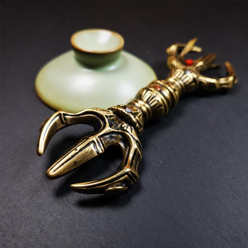 This unique vajra pendant was handmade by Tibetan craftsmen from Tibet in 2000's,from Hepo Town, Baiyu County, the birthplace of the famous Tibetan handicrafts. It is unique flat three - pronged Vajra,made of brass, yellow color,6.3 inches length. In tantric Buddhist practice, the vajra is a potent instrument with multifaceted meaning, symbolizing the adamantine state of existence of a Buddhist practitioner who has reached full enlightenment. The vajra is the archetypal symbol of tantric Buddhism.