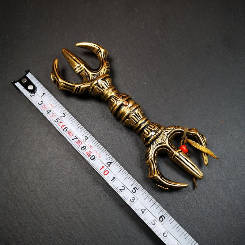 This unique vajra pendant was handmade by Tibetan craftsmen from Tibet in 2000's,from Hepo Town, Baiyu County, the birthplace of the famous Tibetan handicrafts. It is unique flat three - pronged Vajra,made of brass, yellow color,6.3 inches length. In tantric Buddhist practice, the vajra is a potent instrument with multifaceted meaning, symbolizing the adamantine state of existence of a Buddhist practitioner who has reached full enlightenment. The vajra is the archetypal symbol of tantric Buddhism.