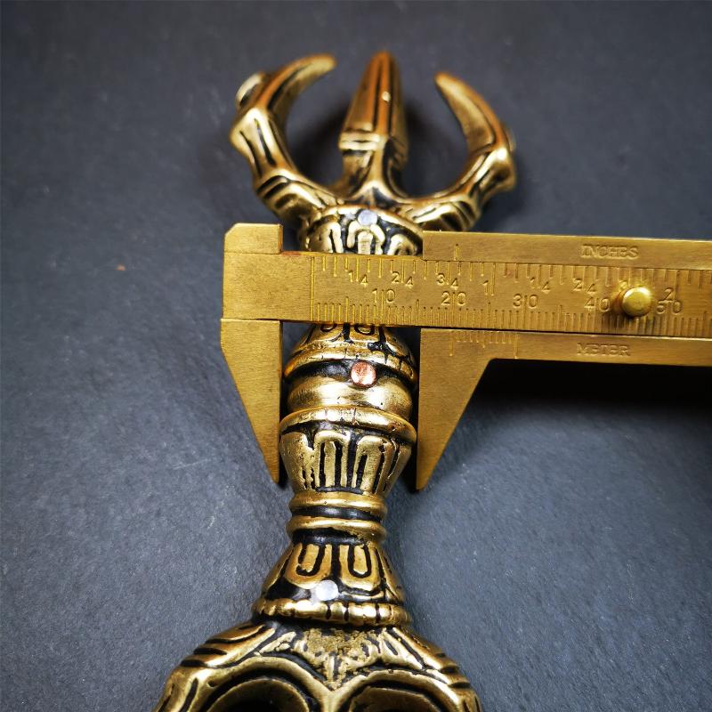 This unique vajra pendant was handmade by Tibetan craftsmen from Tibet in 2000's,from Hepo Town, Baiyu County, the birthplace of the famous Tibetan handicrafts. It is unique flat three - pronged Vajra,made of brass, yellow color,6.3 inches length. In tantric Buddhist practice, the vajra is a potent instrument with multifaceted meaning, symbolizing the adamantine state of existence of a Buddhist practitioner who has reached full enlightenment. The vajra is the archetypal symbol of tantric Buddhism.