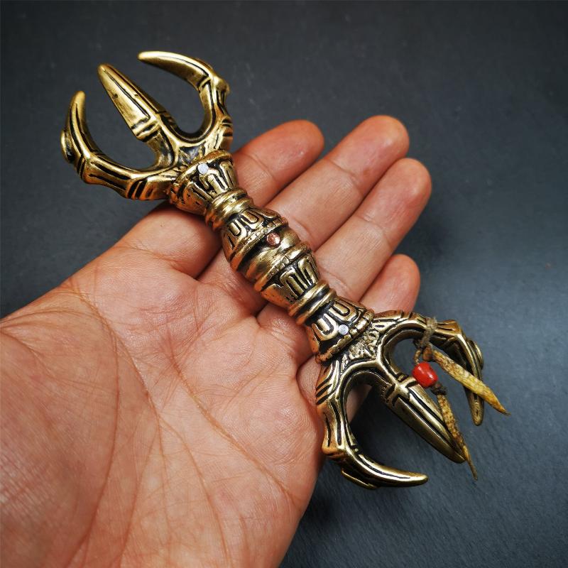 This unique vajra pendant was handmade by Tibetan craftsmen from Tibet in 2000's,from Hepo Town, Baiyu County, the birthplace of the famous Tibetan handicrafts. It is unique flat three - pronged Vajra,made of brass, yellow color,6.3 inches length. In tantric Buddhist practice, the vajra is a potent instrument with multifaceted meaning, symbolizing the adamantine state of existence of a Buddhist practitioner who has reached full enlightenment. The vajra is the archetypal symbol of tantric Buddhism.