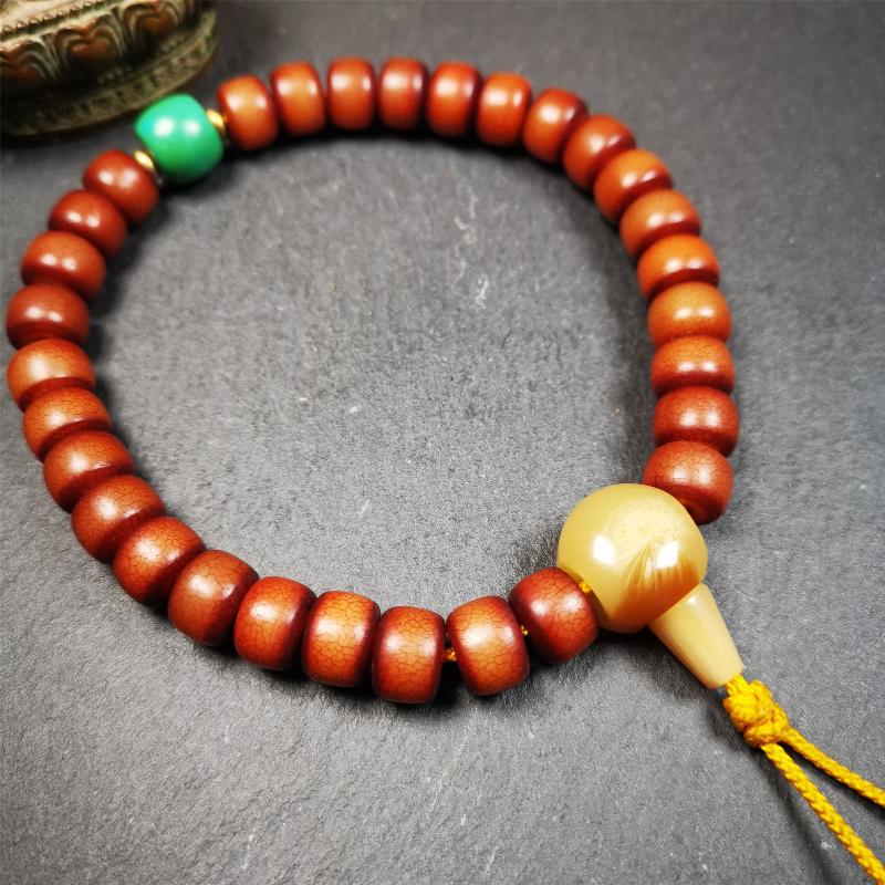 This bracelet mala was made by Tibetan craftsmen and come from Hepo Town, Baiyu County, the birthplace of the famous Tibetan handicrafts. It is made of Corypha Linn Seeds, diameter of 10mm / 0.4",circumference is 26cm / 10" ,with turquoise spacer bead, end of a yak horn guru bead.