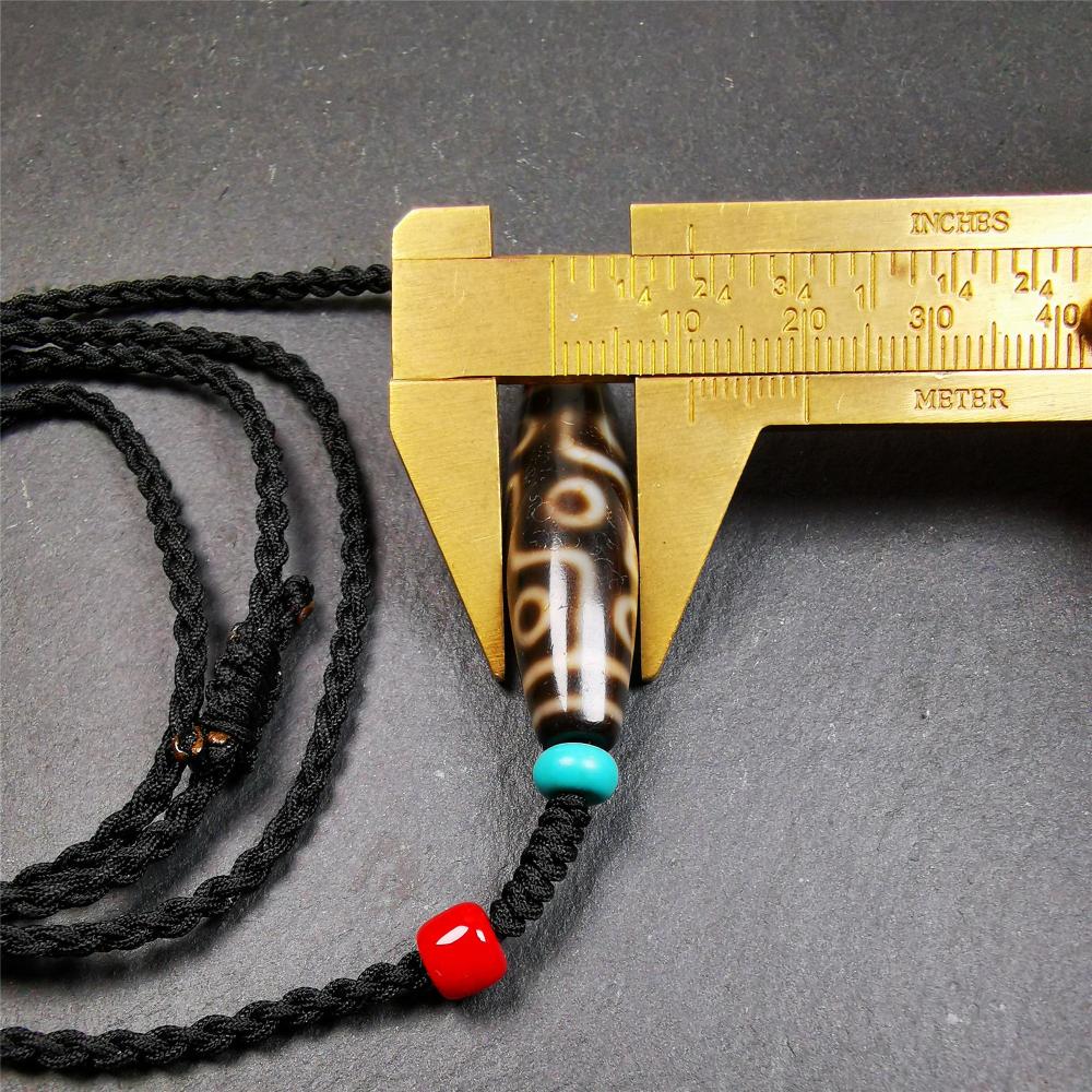 This 9 eyes dzi bead was collected from gerze Tibet,about 40 years old. The necklace was hand-woven by Tibetans from Baiyu County, the main bead is a brown color 9 eyes dzi, paired with 2 turquoise beads and 2 red agate beads.
