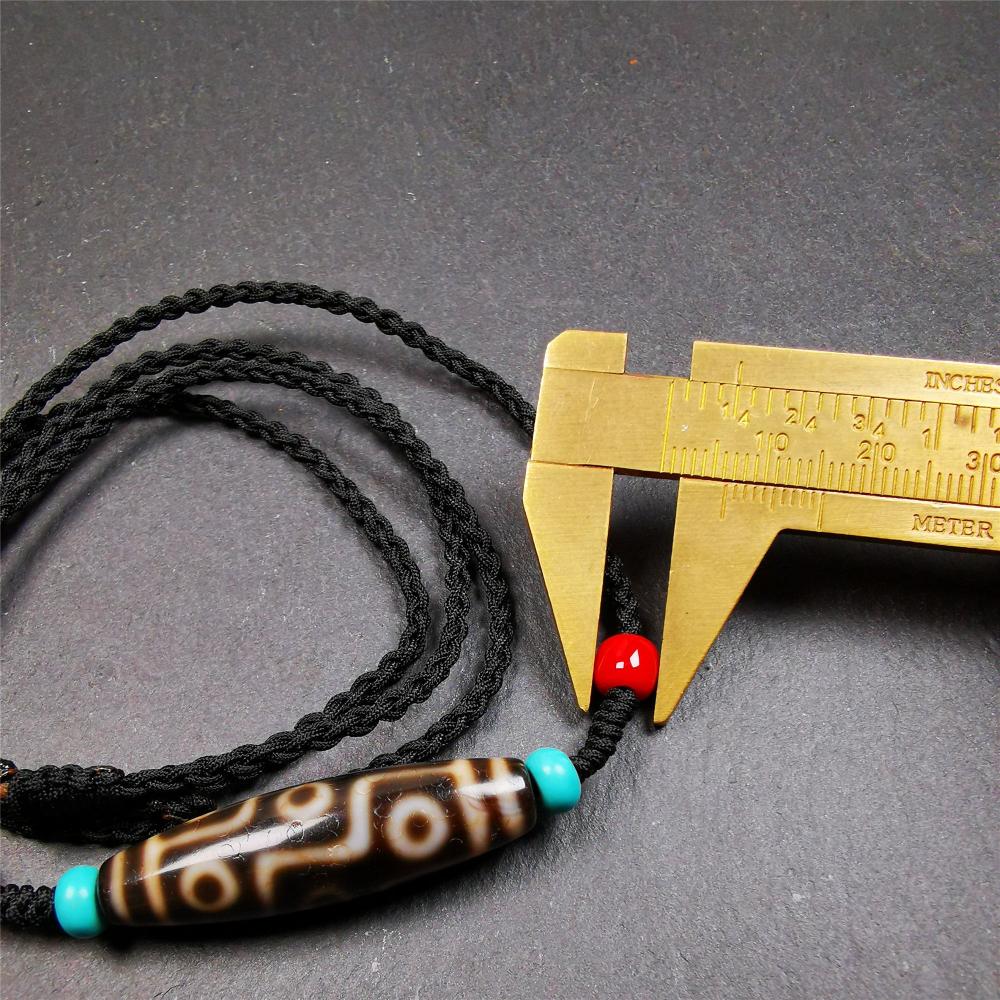 This 9 eyes dzi bead was collected from gerze Tibet,about 40 years old. The necklace was hand-woven by Tibetans from Baiyu County, the main bead is a brown color 9 eyes dzi, paired with 2 turquoise beads and 2 red agate beads.